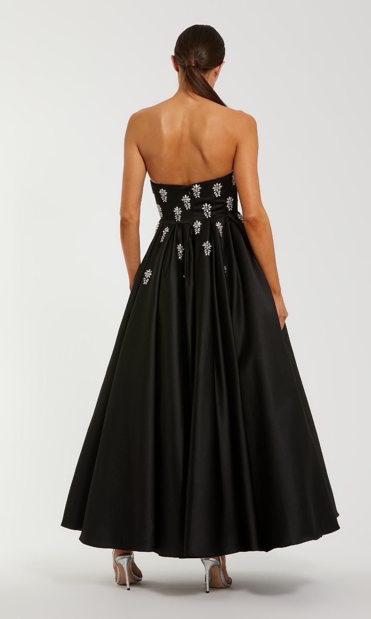 Black strapless dress with an a-line skirt on a white background